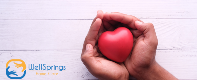 Hands holding a heart shape represent the care and support that those caring for seniors at home need.