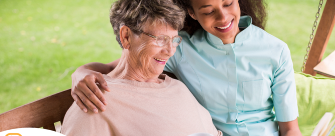 Professional caregivers like this one who is reading a book with a senior client can help them stay mentally active and engaged.