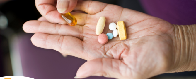 A woman holds pills in her hand, representing medication management.