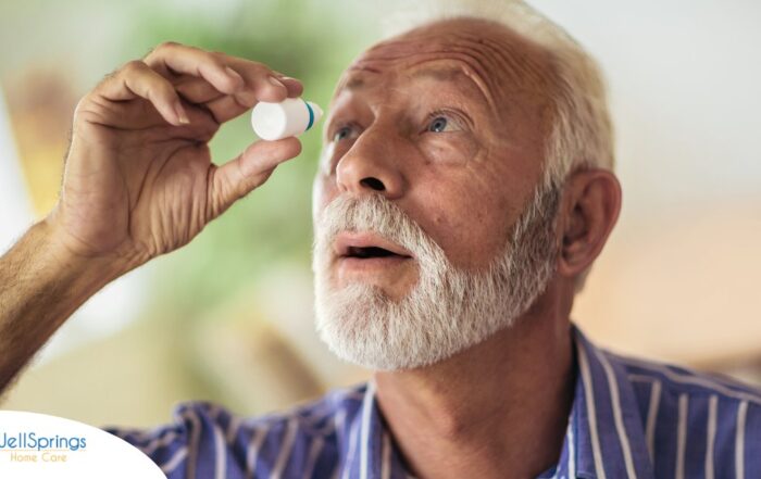 An older man uses eye drops as part of a good care routine to maintain his vision health.